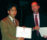 ERCIM president Gerard van Oortmerssen (right) presents the Cor Baayen Award to Phong Q. Nguyen during a ceremony in Crete on 31 October 2001. 