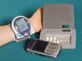 Figure 2: Bluetooth attached blood pressure cuff, Bang & Olufssen Medicom IDAS II medication device, mobile phone as hub device.